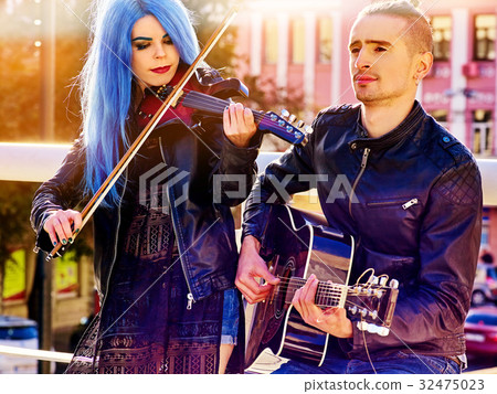 Woman and man perform music on violin city outdoor Woman and man perform music on violin city outdoor 32475023