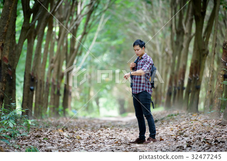 Happy Asian man backpack look at the wrist watch Happy Asian man backpack look at the wrist watch 32477245
