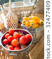 Holland Cherry Tomato in bucket on wood table 32477409