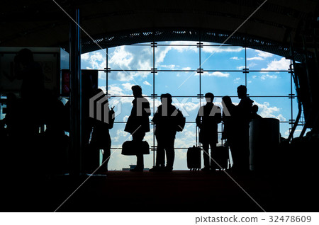 Silhouettes of people waiting for their flight at Silhouettes of people waiting for their flight at 32478609