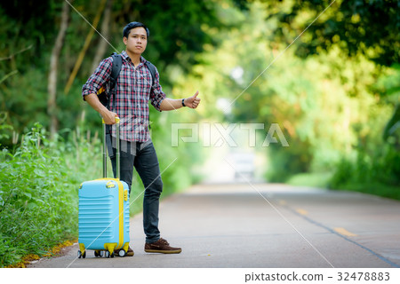 Backpacker is hitchhiking. 32478883