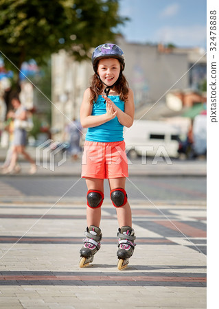 Cute little girl learning to roller skate in city Cute little girl learning to roller skate in city 32478888