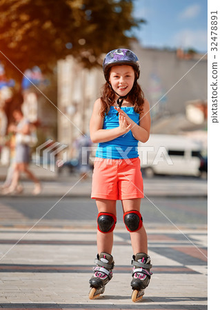 Cute little girl learning to roller skate in city Cute little girl learning to roller skate in city 32478891