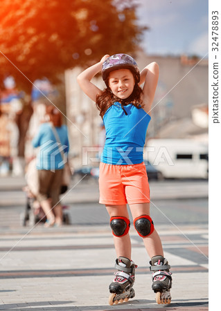 Cute little girl learning to roller skate in city Cute little girl learning to roller skate in city 32478893
