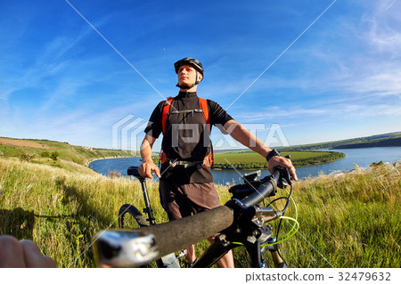 Traveler has adventur on meadow on riverside Traveler has adventur on meadow on riverside 32479632