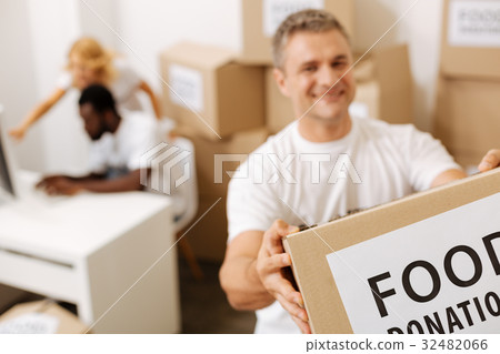 Capable friendly man taking contributions from 32482066