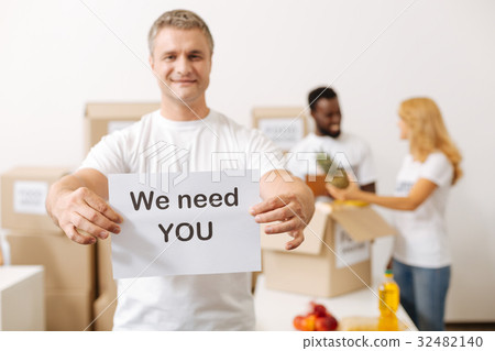 Handsome nice guy encouraging volunteering 32482140