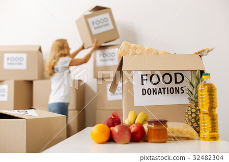 Energetic committed woman moving the packages 32482304
