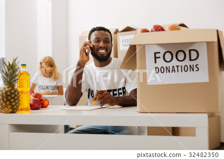 Energetic friendly man confirming the shipment 32482350