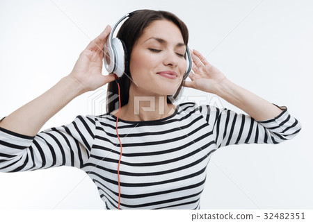 Positive delighted brunette putting hands on Positive delighted brunette putting hands on 32482351