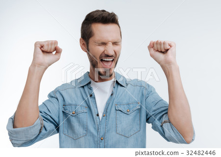 Satisfied bearded man feeling happiness at the Satisfied bearded man feeling happiness at the 32482446