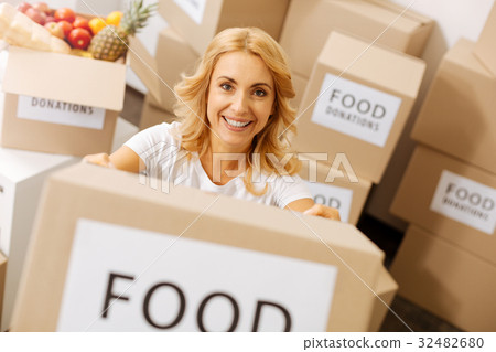 Admirable generous lady holding a box full of 32482680