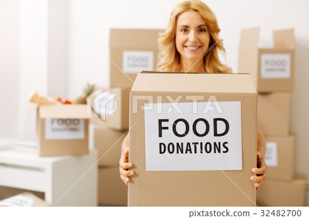 Lovely friendly woman giving out boxes with food 32482700