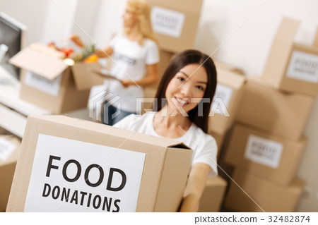 Beautiful admirable woman helping needy people 32482874