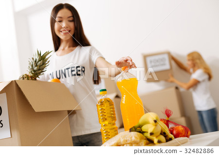 Dedicated altruistic woman canvassing the package 32482886