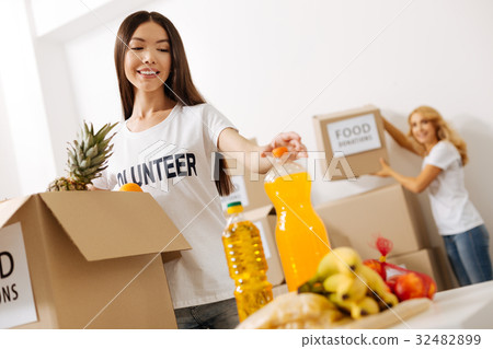 Smart enthusiastic woman picking a bottle for 32482899