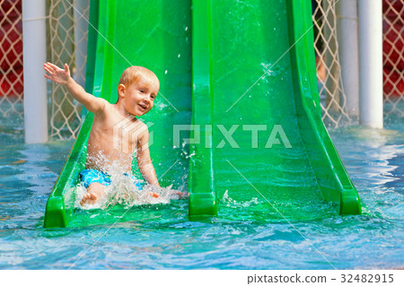 Child has a fun in aqua park swimming pool 32482915