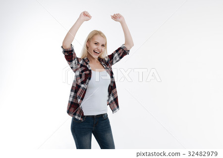 Positive delighted girl celebrating her win 32482979