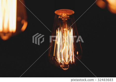 Close-up of glowing retro light bulbs on a black Close-up of glowing retro light bulbs on a black 32483683