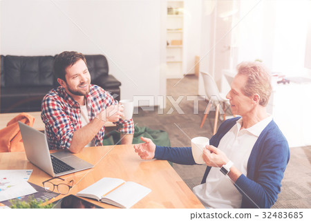 Positive colleagues having a lively talk at work Positive colleagues having a lively talk at work 32483685