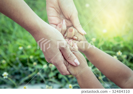 child and mother holding hand together with love child and mother holding hand together with love 32484310