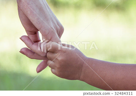 child and mother holding hand together with love child and mother holding hand together with love 32484311