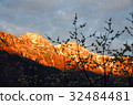 sunlight over summit of mountain in austria 32484481