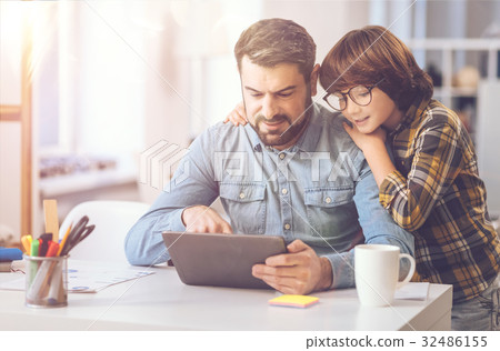 Nice cute child standing near his father 32486155