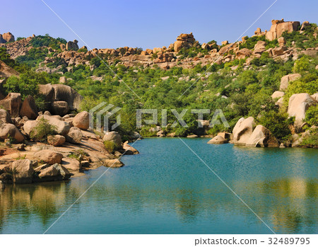 Blue waters of Tungabhadra River in Hampi, India Blue waters of Tungabhadra River in Hampi, India 32489795