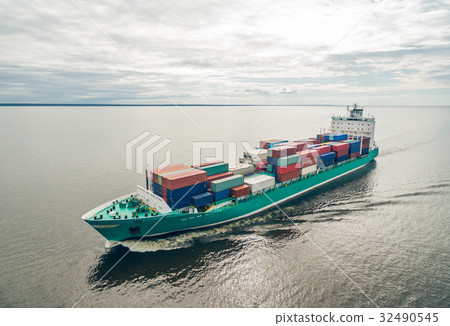Aerial view of container ship sailing in sea Aerial view of container ship sailing in sea 32490545