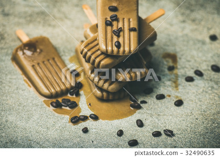 Flatlay of melting coffee latte popsicles with Flatlay of melting coffee latte popsicles with 32490635