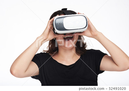Surprised woman watching virtual reality 32491020