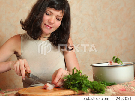 housewife cooking with chicken meat and green dill housewife cooking with chicken meat and green dill 32492051