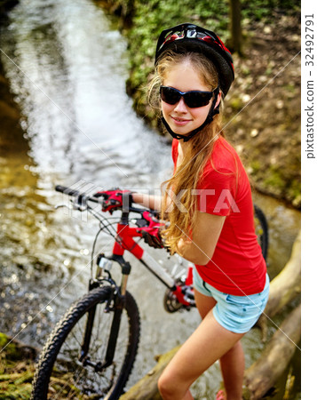 Bicycle teen with ladies bikes in summer park Bicycle teen with ladies bikes in summer park 32492791