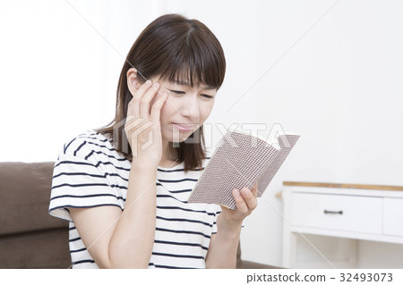 A young woman reading and impressing 32493073
