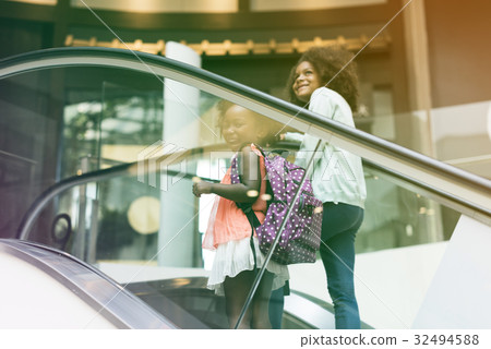Little Girls going up by escalator 32494588