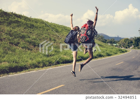 Diverse Backpacker Women Jumping on The Street 32494851