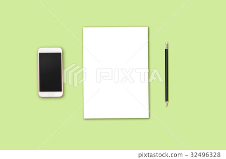 Modern workplace with smartphone, blank paper and pencil copy space on green background. Top view. Flat lay style. Modern workplace with smartphone, blank paper and pencil copy space on green background. Top view. Flat lay style. 32496328