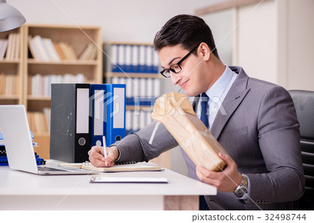 Businessman receiving parcel in the office Businessman receiving parcel in the office 32498744