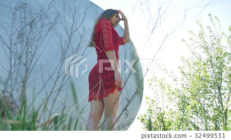 sexy girl. A serious sexy girl stands near barrel 32499531
