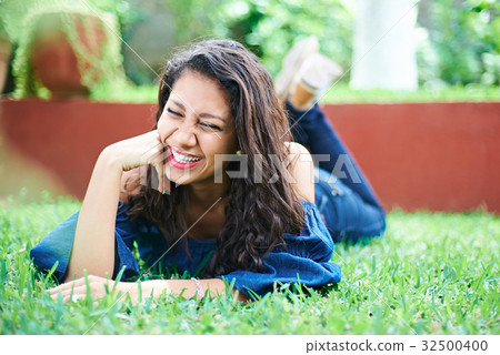laughing girl on grass 32500400