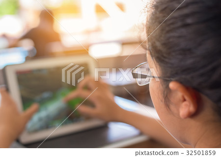 girl touching on screen of tablet. girl touching on screen of tablet. 32501859