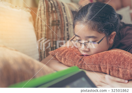 Asian cute girl looking on screen of tablet Asian cute girl looking on screen of tablet 32501862