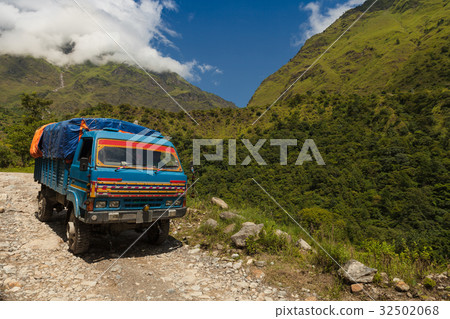 The truck is on altitude road in Nepal. 32502068