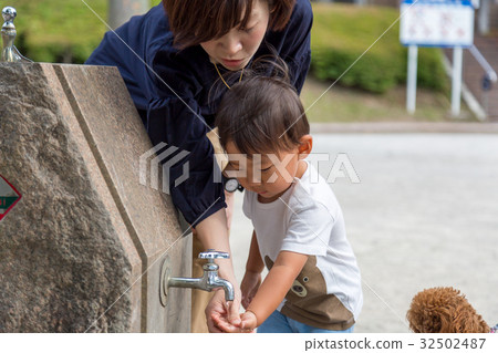 Parent and child hand washing in the park Parent and child hand washing in the park 32502487