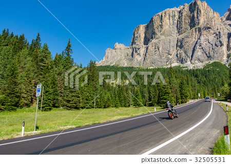 Mountain road with motorbike in Dolomites 32505531