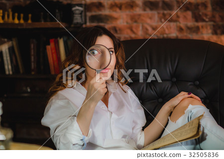 funny woman looking through a magnifying glass funny woman looking through a magnifying glass 32505836