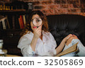 funny woman looking through a magnifying glass 32505869