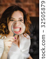 funny woman smiling and show teeth through a 32505879