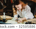 funny woman looking through a magnifying glass to 32505886